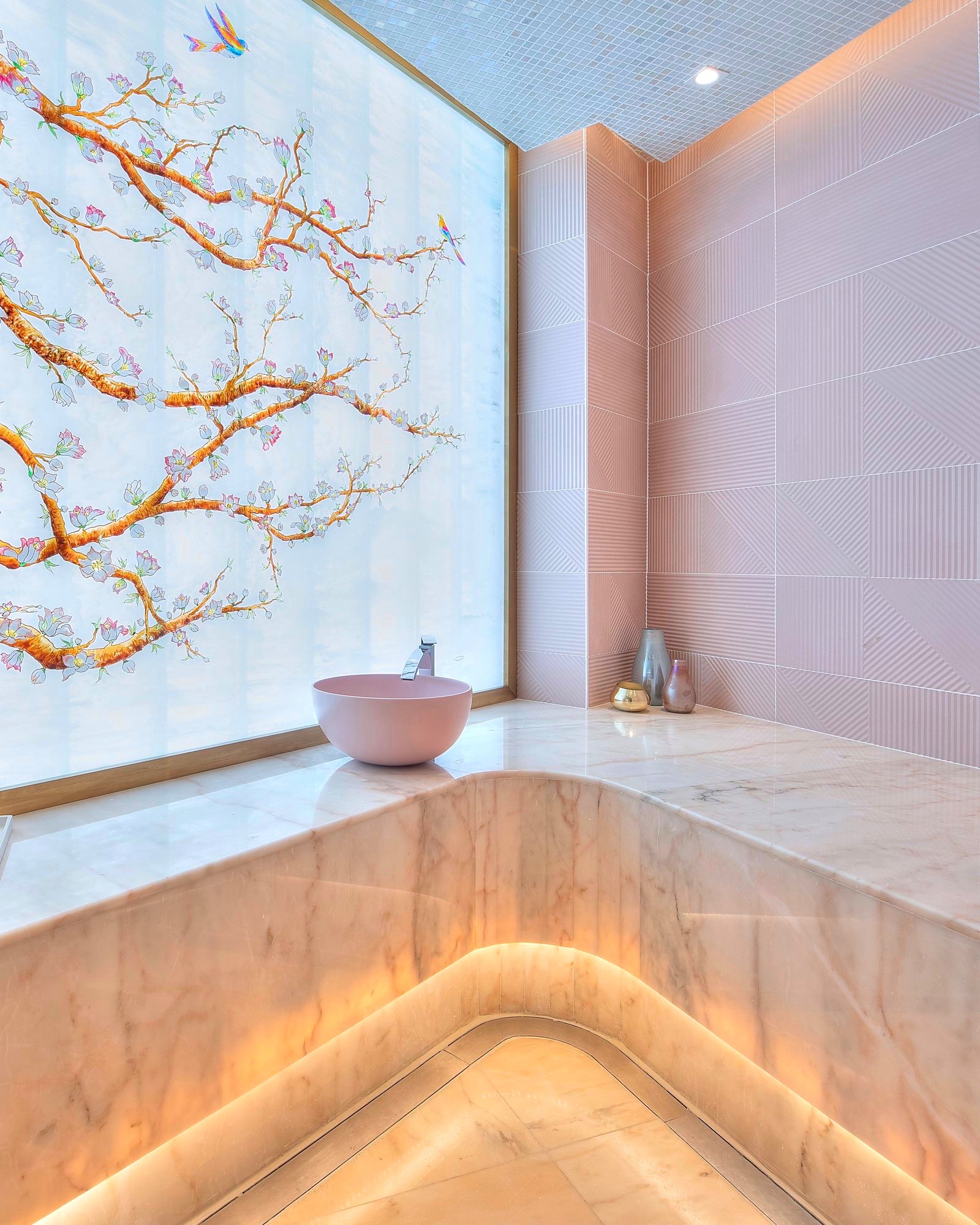The marble Moroccan bath at Sheikha Fatima Park beneath the hand-painted blossom mural