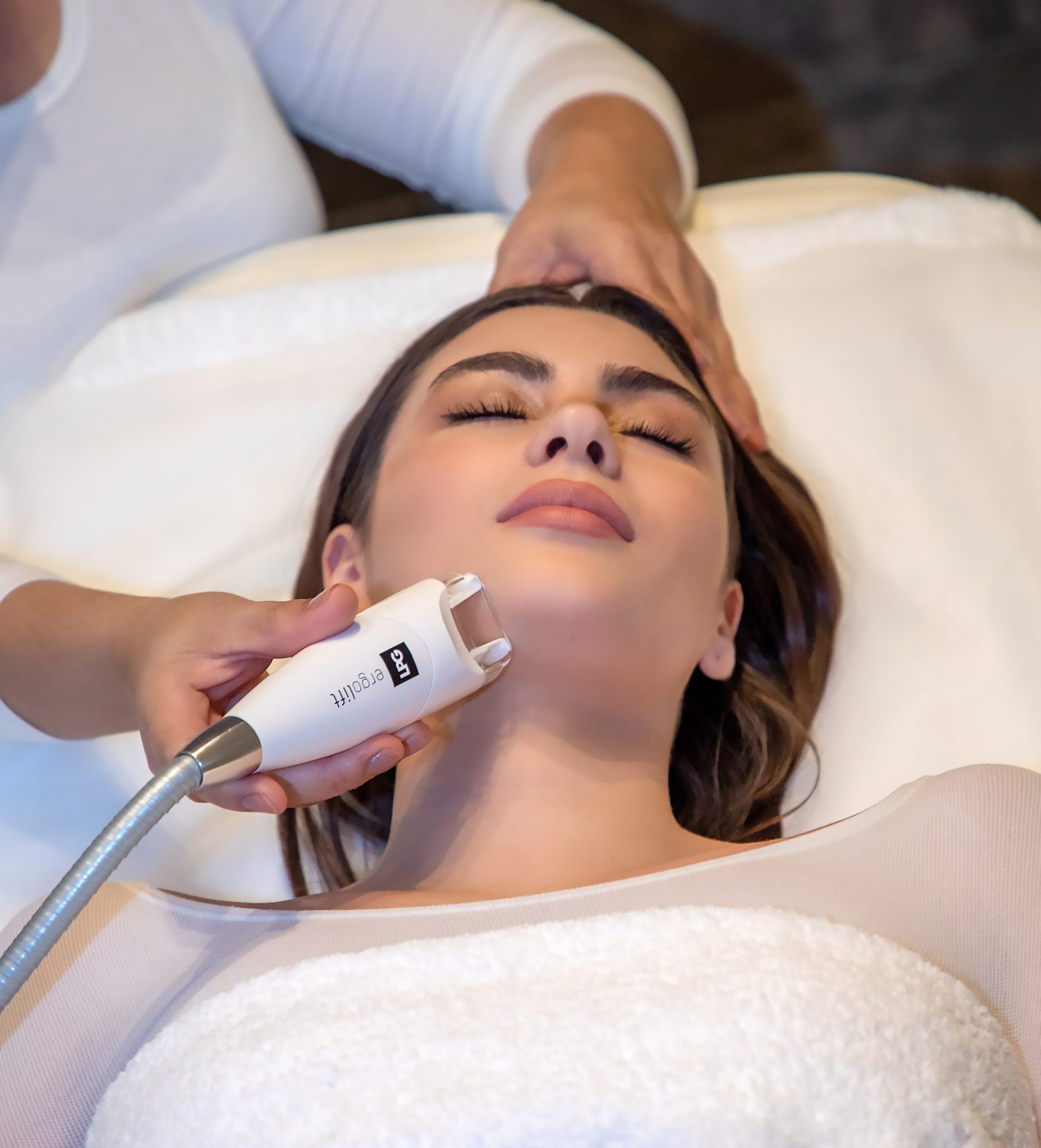 An LPG Endermologie facial at Bellacure, the handpiece gliding along the jaw