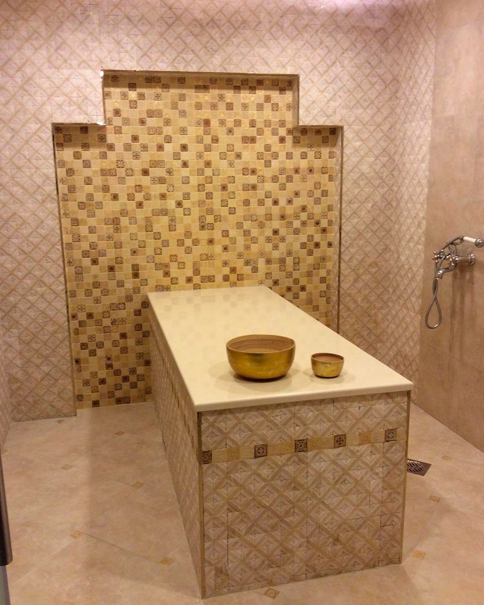 The Moroccan bath at Bellacure Al Seef Village Mall: a mosaic-tiled hammam with a marble table