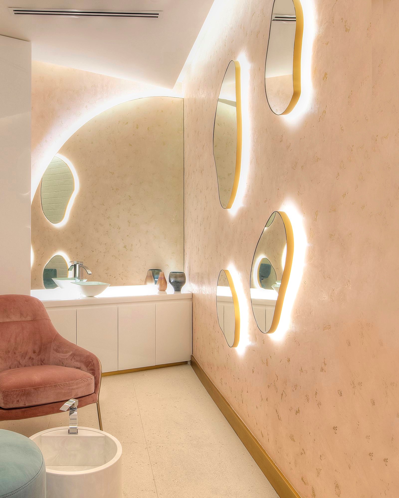 The VIP make-up room at Bellacure Sheikha Fatima Park: backlit pebble mirrors and a blush velvet chair