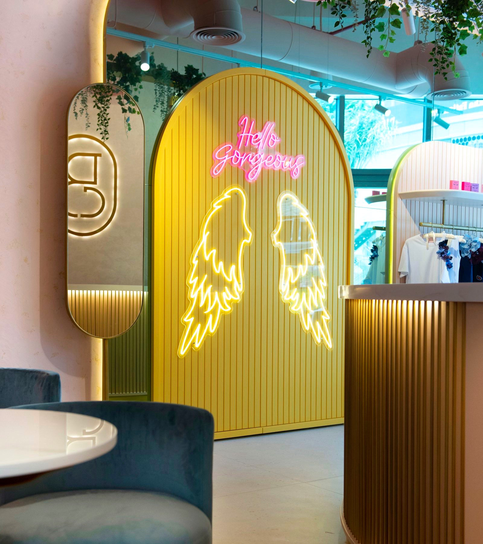 The Hello Gorgeous neon and angel wings on the gold arch in the Bellacure lounge at Sheikha Fatima Park